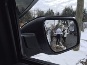 Chief Dodge helps a woman by the road.