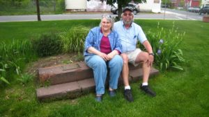 Linda and Jim Bartlett at a monument in the Maple High-Six Corners neighborhood. The stairs came from a house that was damaged in the tornado.