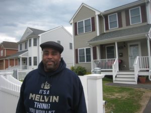 Springfield City Councilor Melvin Edwards standing in front of new homes on Central Street built after the 2011 tornado.